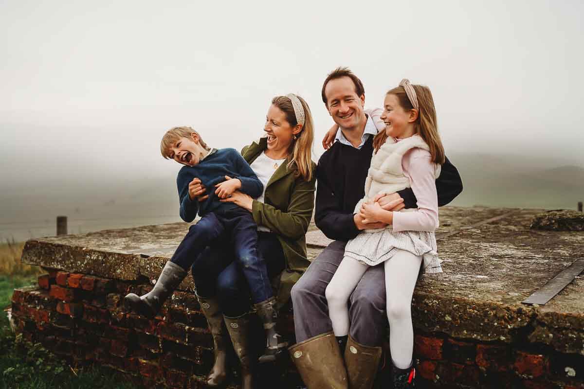 a family cuddling for a photo with a family photographer in Marlborough