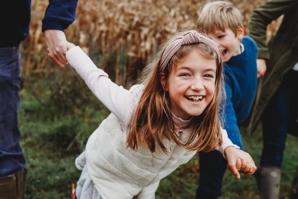 a girl laughing at the camera for a family photographer in Marlborough