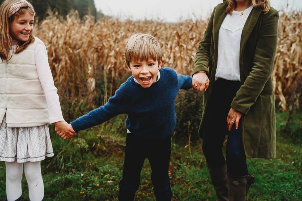 a little boy laughing and having fun during a shoot for a malrborough family photographer