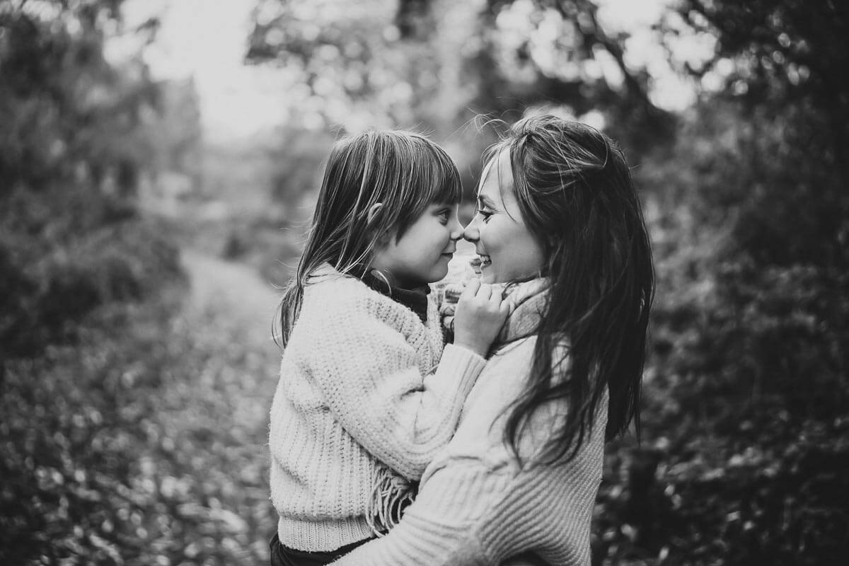 a mother and daughter touching noses for a family photoshoot in Oxford