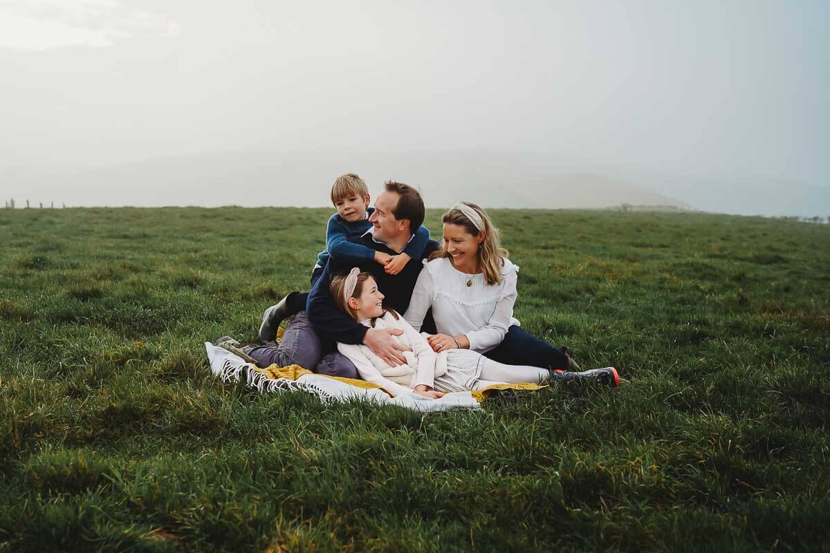 a family snuggling up for a family photoshoot with a Marlborough photographer