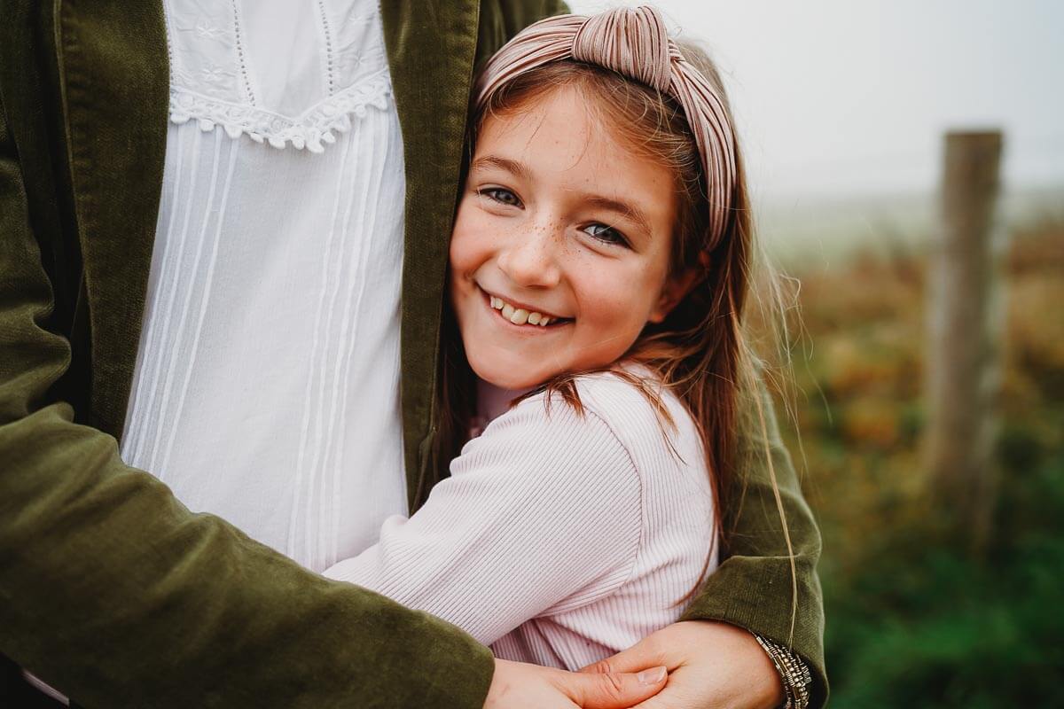 a daughter hugging her mum for a photoshoot in Marlborough