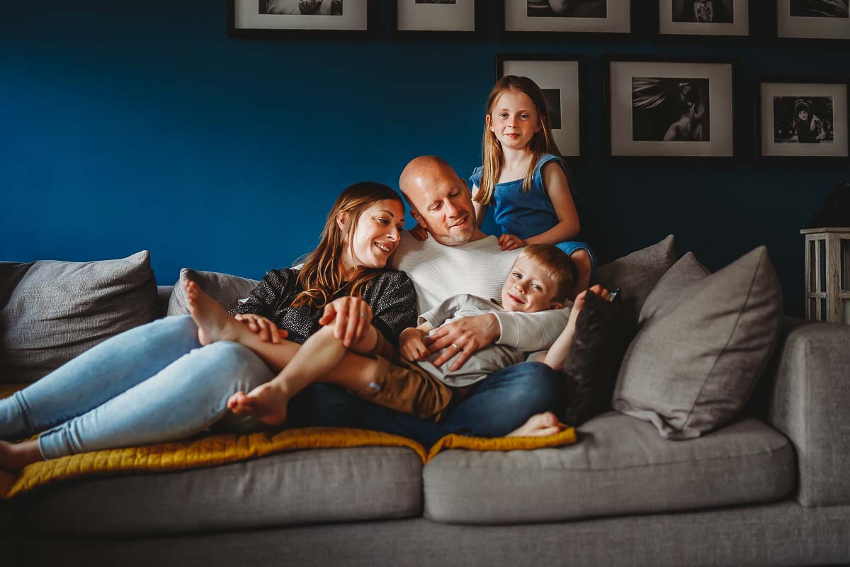 a family cuddling on the sofa during a family photoshoot Newbury