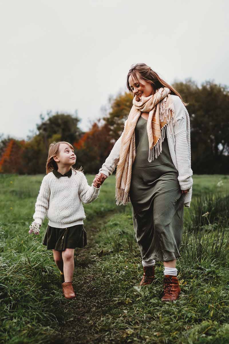 mother and daughter walking and holding hands for a lifestyle photographer