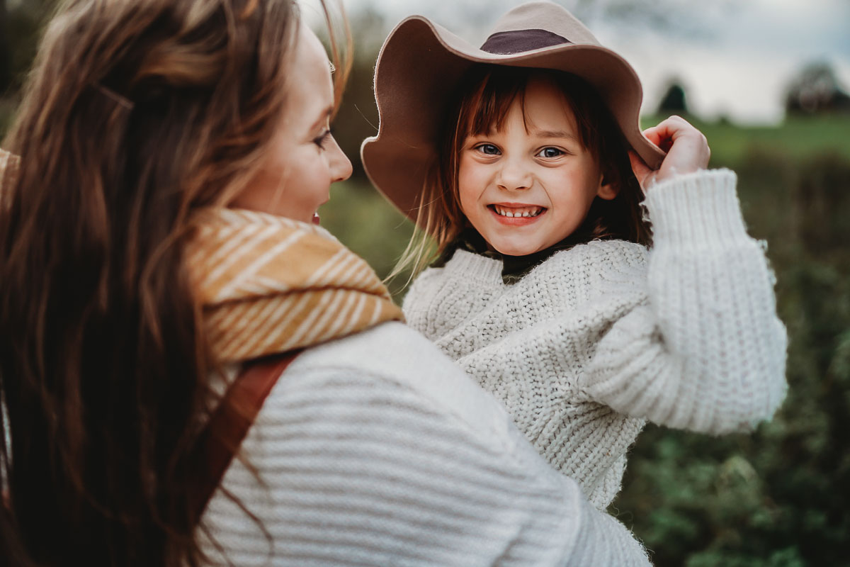 a little girl wearing a hat for a family photographer in oxford