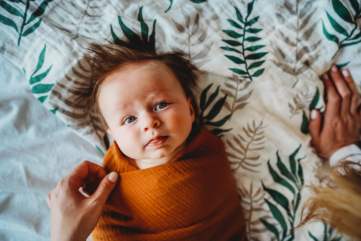 newborn baby looking up at the camera during a newbury photoshoot