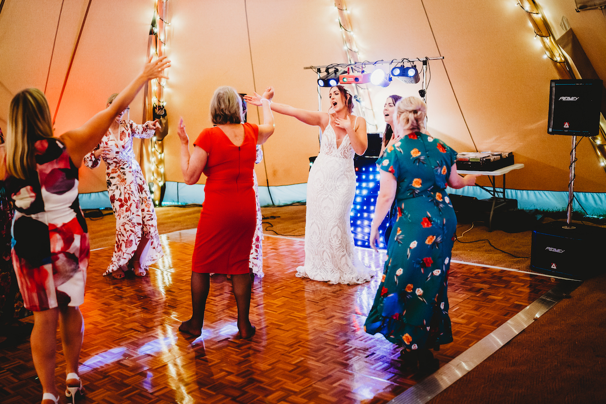 a bride dancing and singing on the dance floor during her wedding taken by a newbury wedding photographer