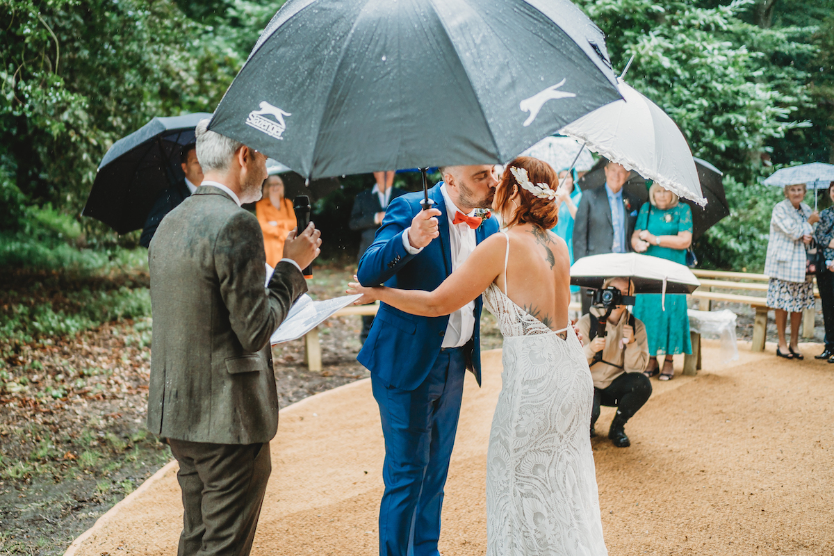 bride & groom kiss during their woodland ceremony