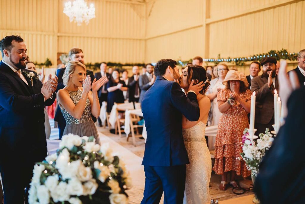 bride kissing her husband at a Herons Farm wedding in Reading 