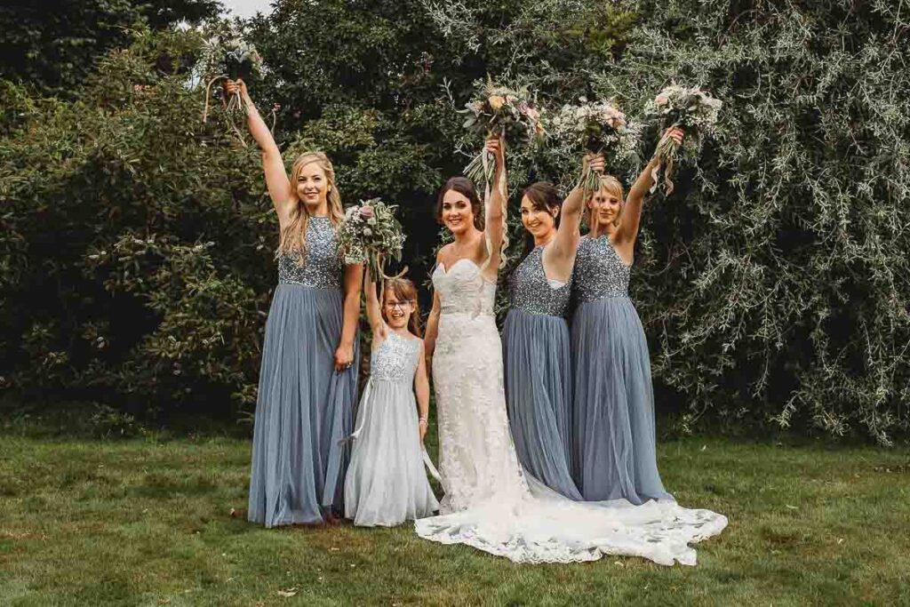 bridesmaids cheering with their bouquets at Herons Farm Reading 