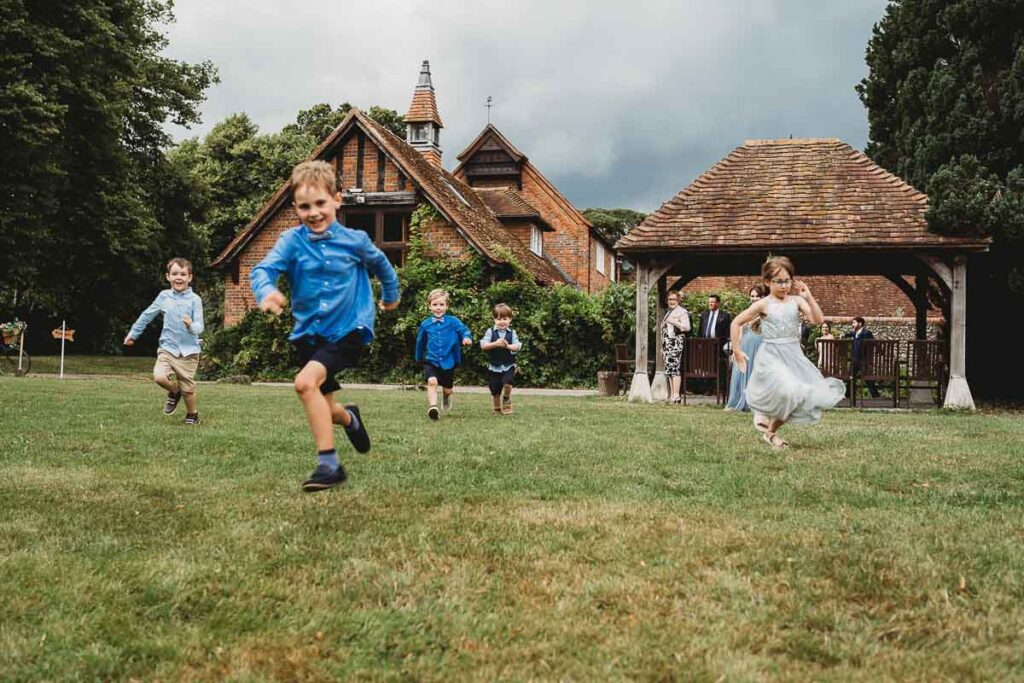 kids having a running race at Barn wedding venue 