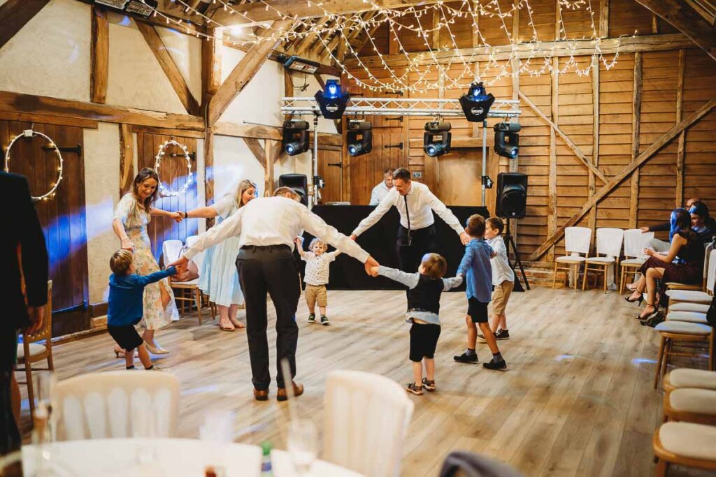 families dancing at a wedding at Herons Farm Barn 