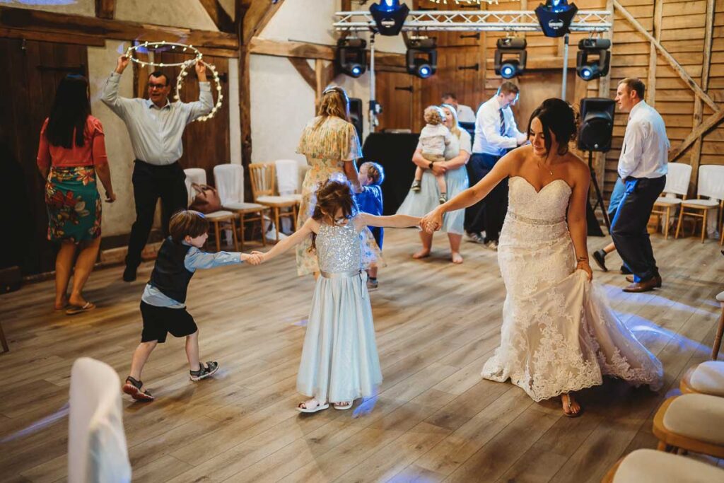 Bride dancing with children at a wedding at Herons Farm Reading 