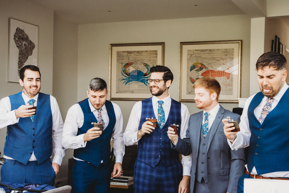 grooms men sipping from their flasks and pulling disgusted faces