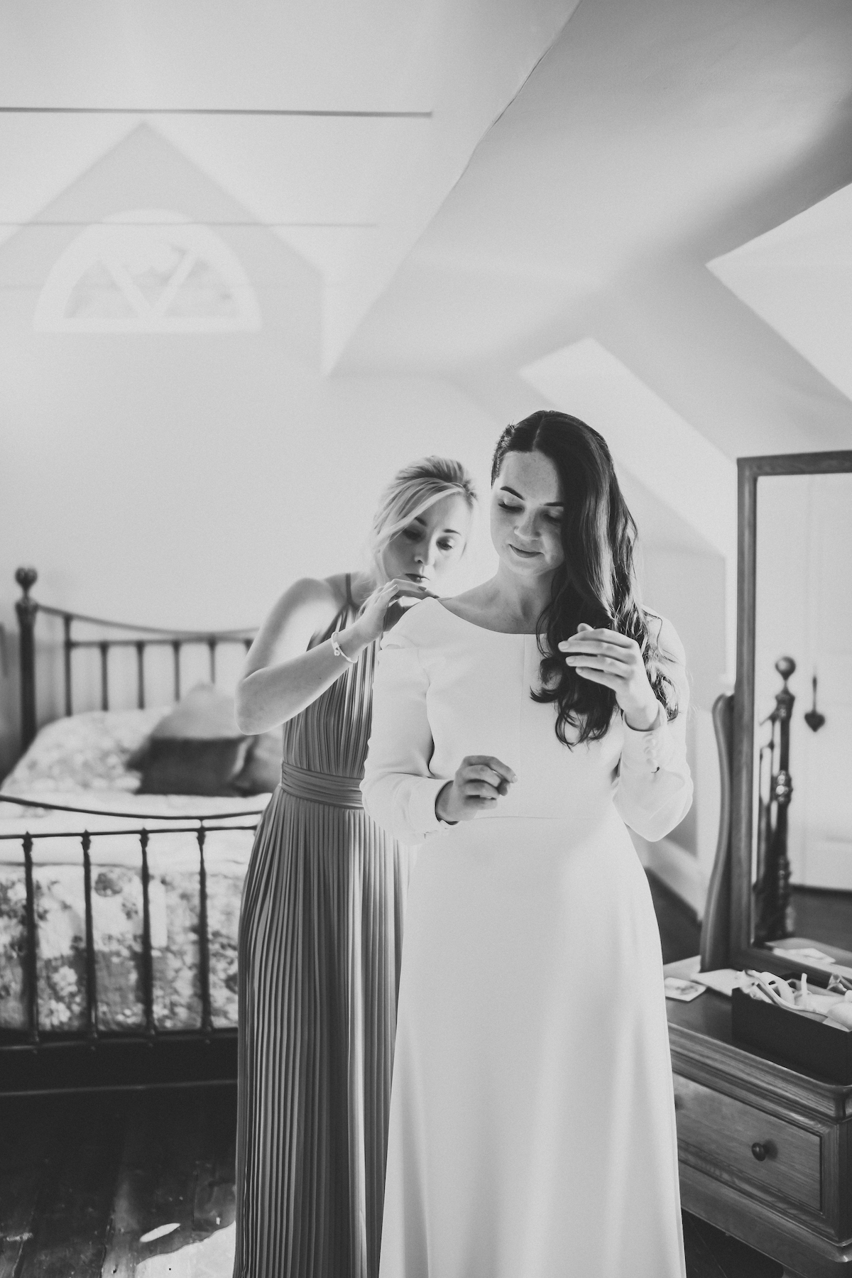 bride getting into her dress ready for her wedding in Berkshire