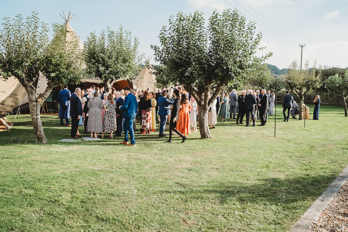 guests mingling in the sun ahead of a wedding in Berkshire