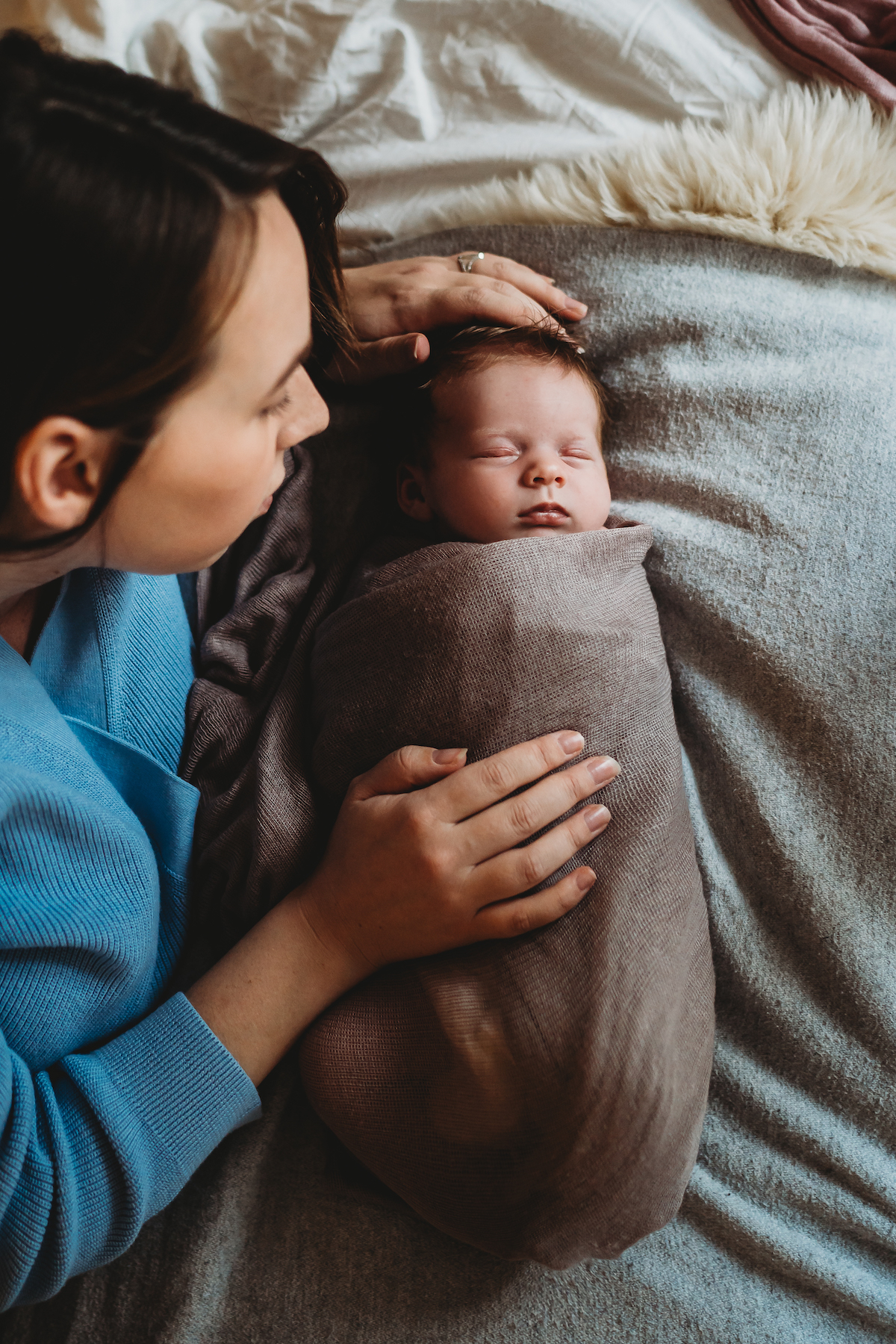 Baby photographer in Newbury's photo of a Mother looking down at her newborn baby whilst she sleeps