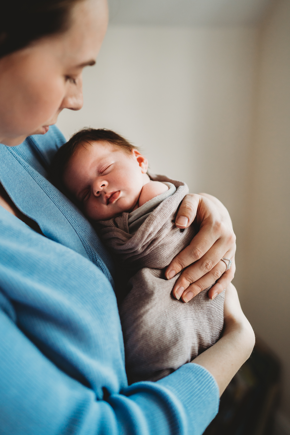 sleeping baby being cuddled by mum for a baby photographer newbury