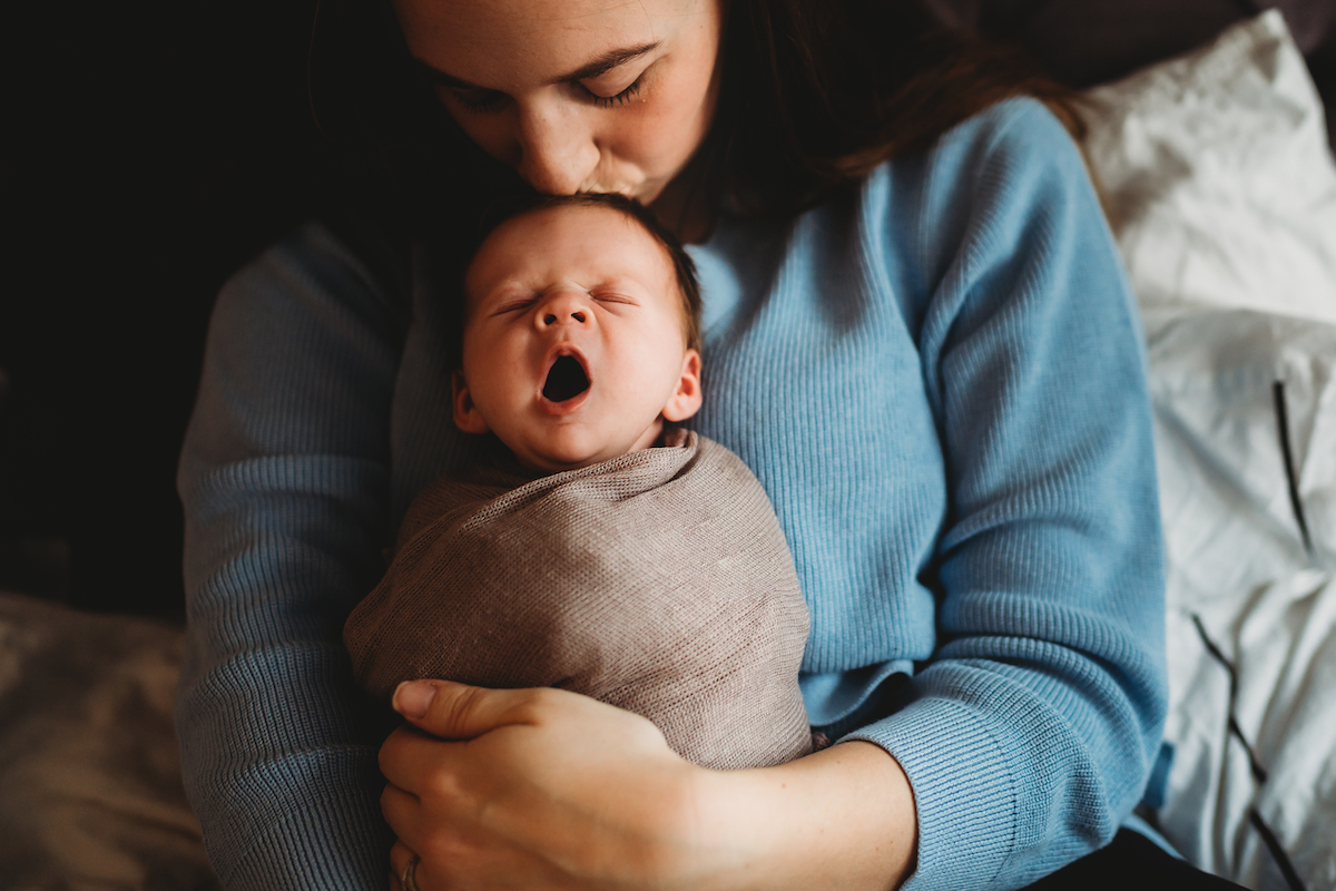 a baby yawning for a newborn photographer in newbury