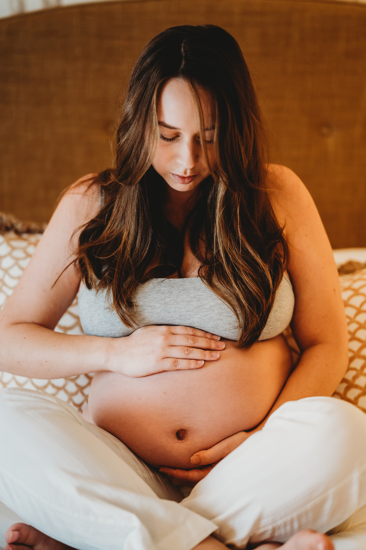 a mother to be holding her bump ready for a pregnancy photo shoot in newbury