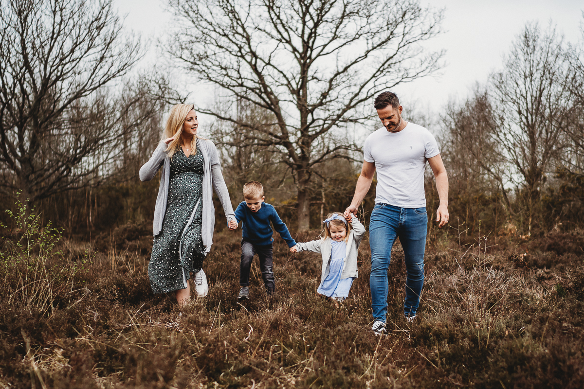 family walking and chatting in woodland