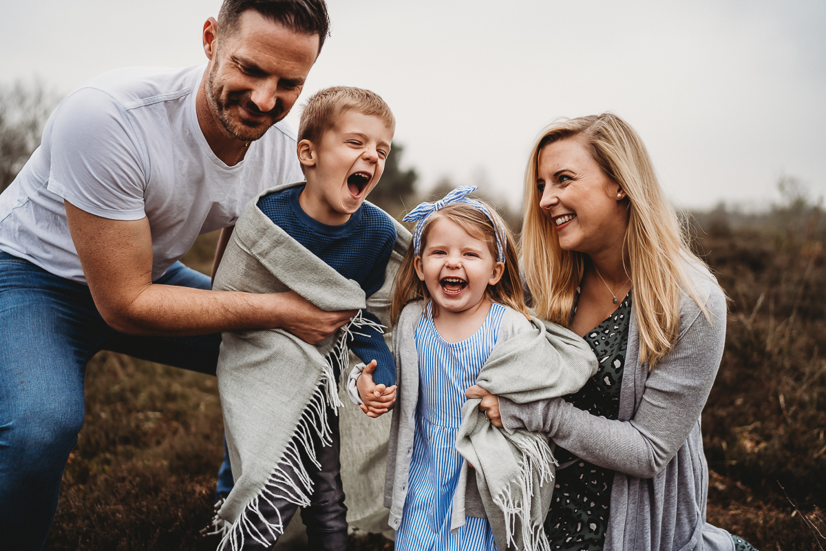 parents hugging their children and laughing for a thatcham family photographer