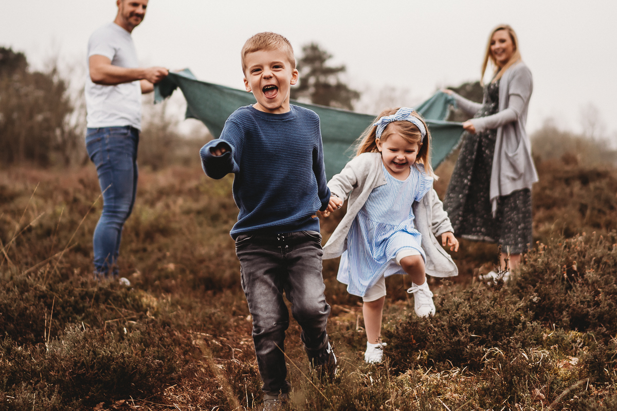 children running through heathland laughing 