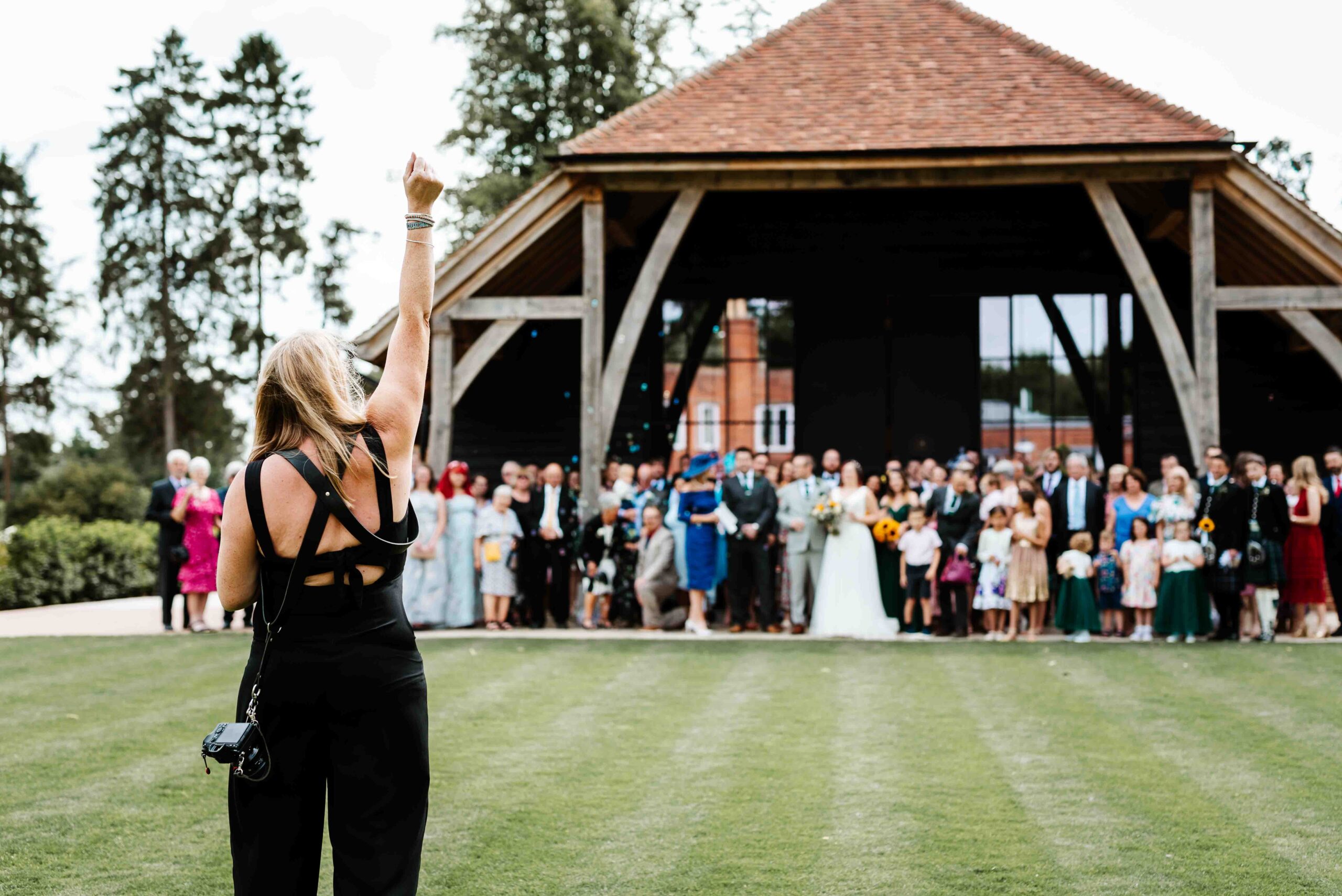 a berkshire wedding photographer trying to get her whole wedding party in line