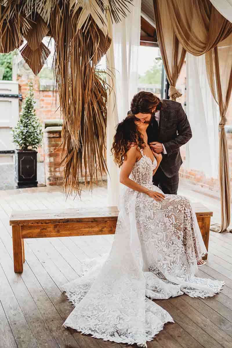 a bride and groom sharing a kiss for a cotswold wedding photographer