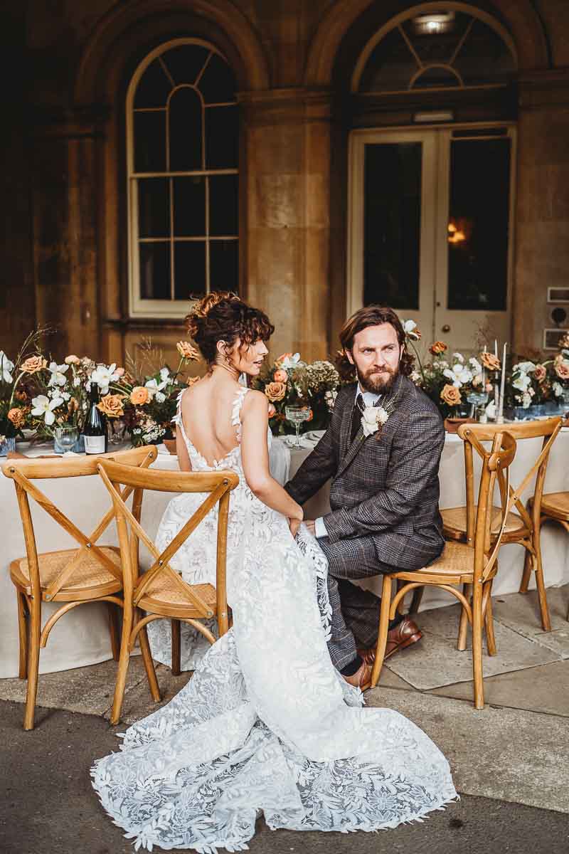 An image of a bride and groom seated at their head table taken by a cotswold wedding photographer