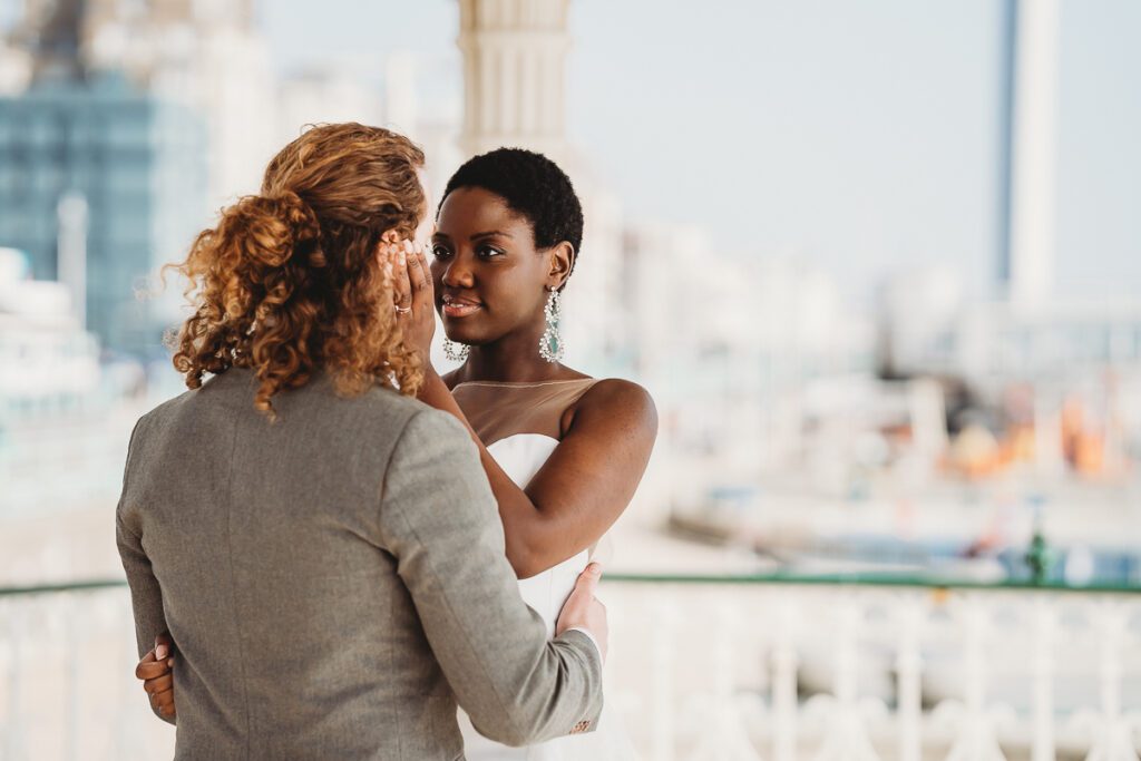 a bride and groom faciung each other looking into each others eyes after their city elopement