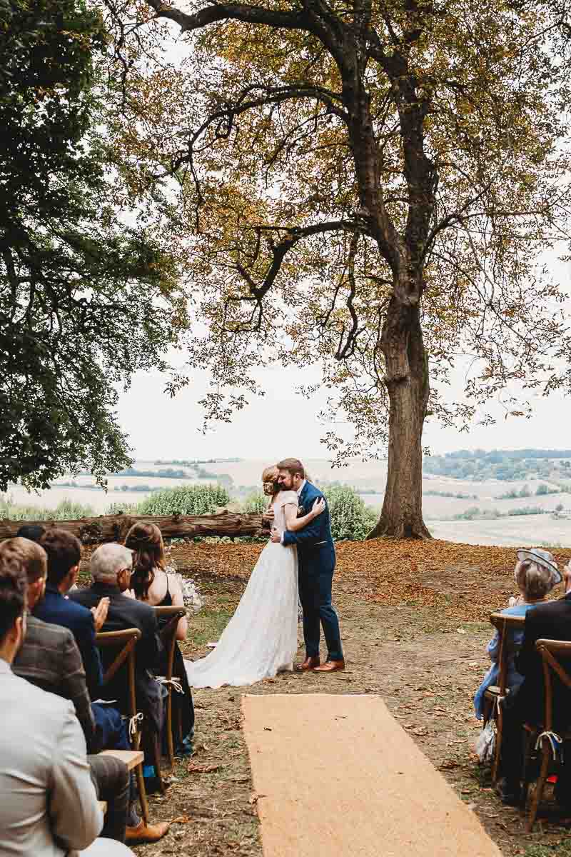 a bride and groom hugging after they got married during a woodland ceremony taken by an oxfordshire wedding photographer