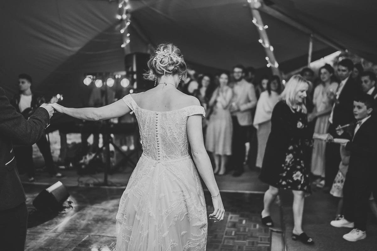 a bride being led on to the dance floor by her husband during their wedding taken by a berkshire wedding photographer