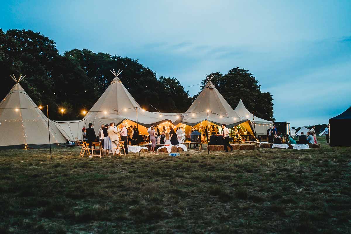 forest edge tipis holding a wedding taken at sunset