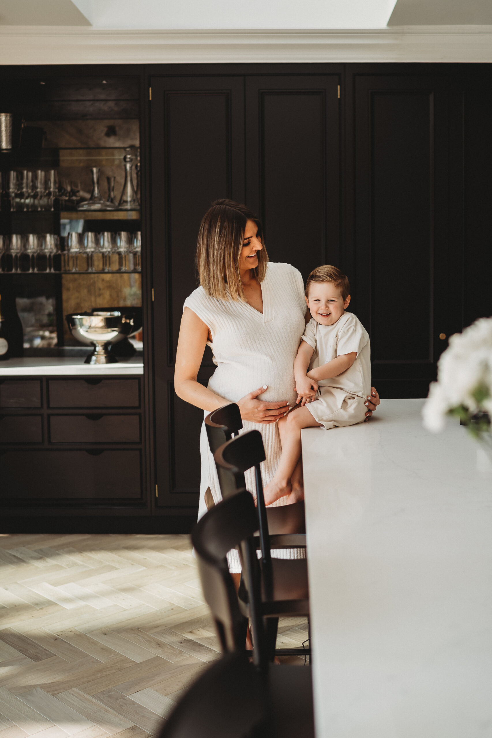 mum and son in a kitchen for their relaxed in-home maternity photoshoot in Windsor