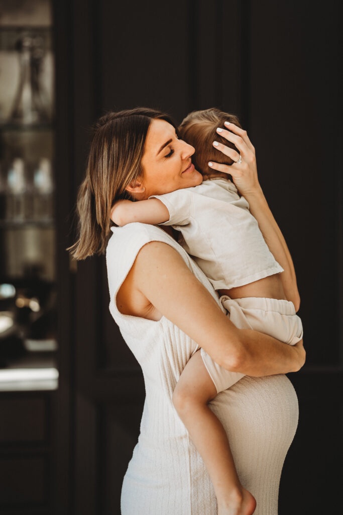 mum and son hugging for a relaxed pregnancy photoshoot in Windsor