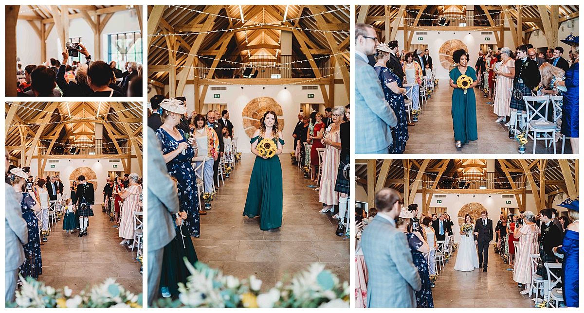 The bridal party walking down the aisle ahead of the bride at the Post barn Newbury
