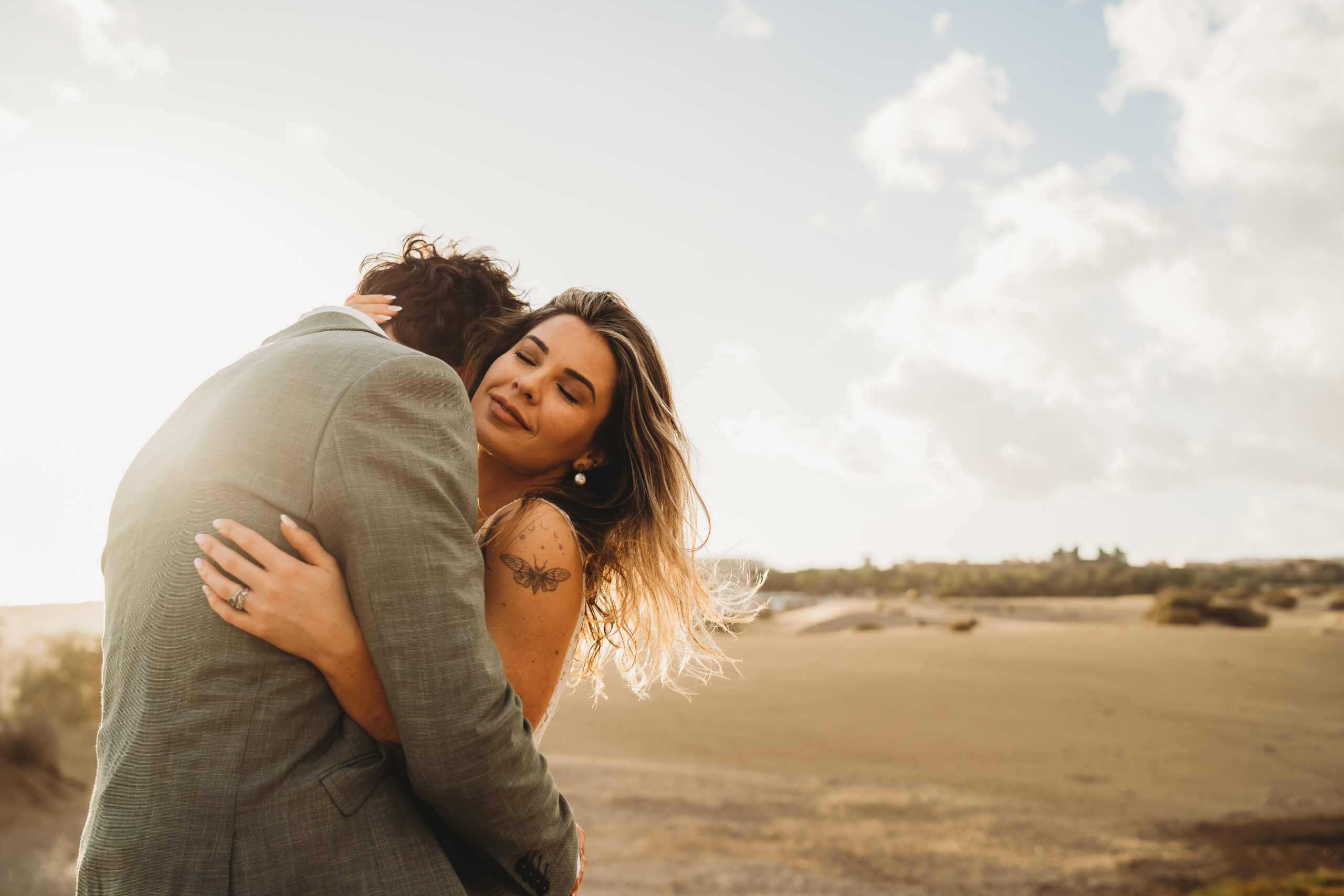 a couple cuddling together after their elopement, taken by a destination wedding photographer