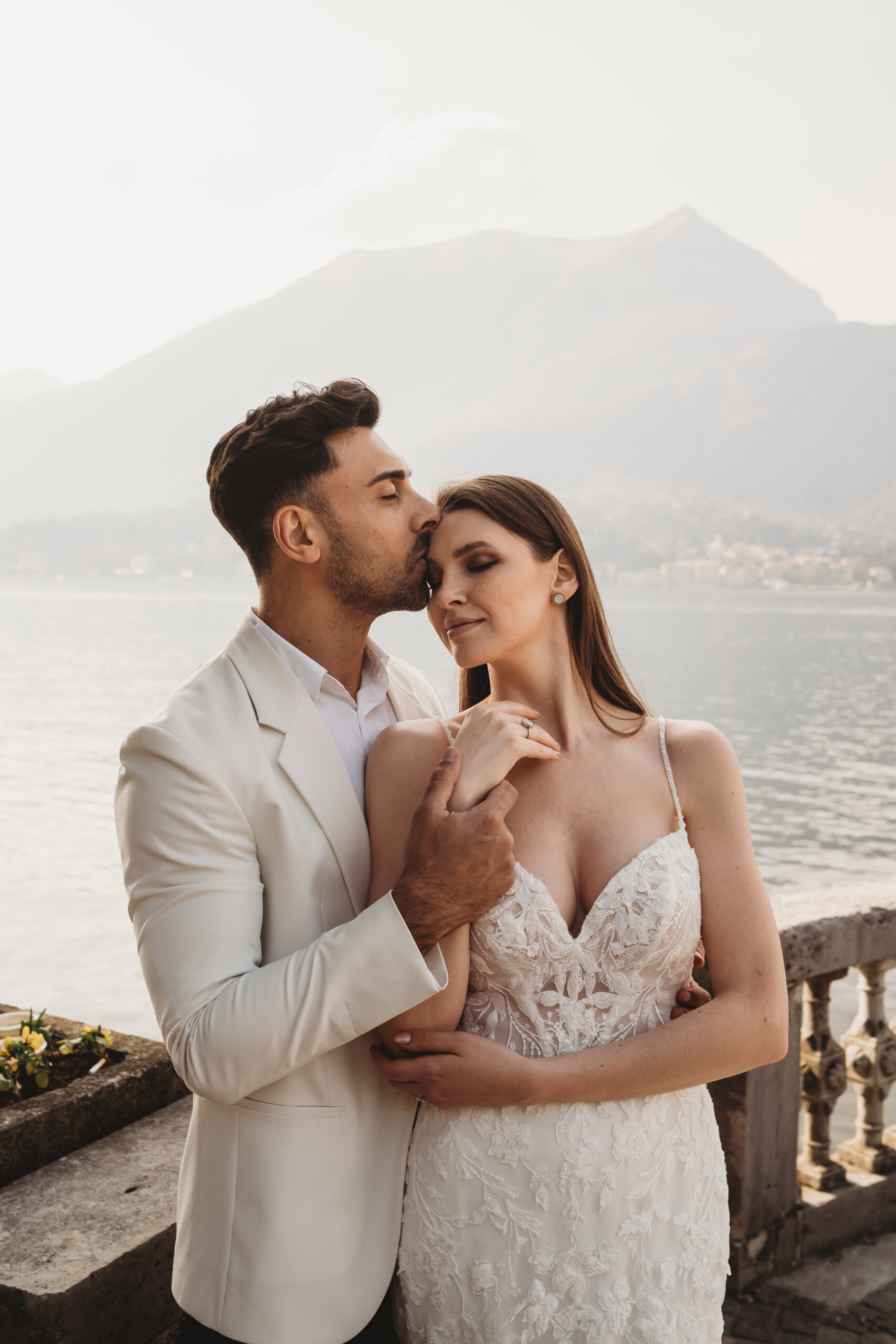 a bride and groom posing for a lake como photographer after their villa wedding in Italy