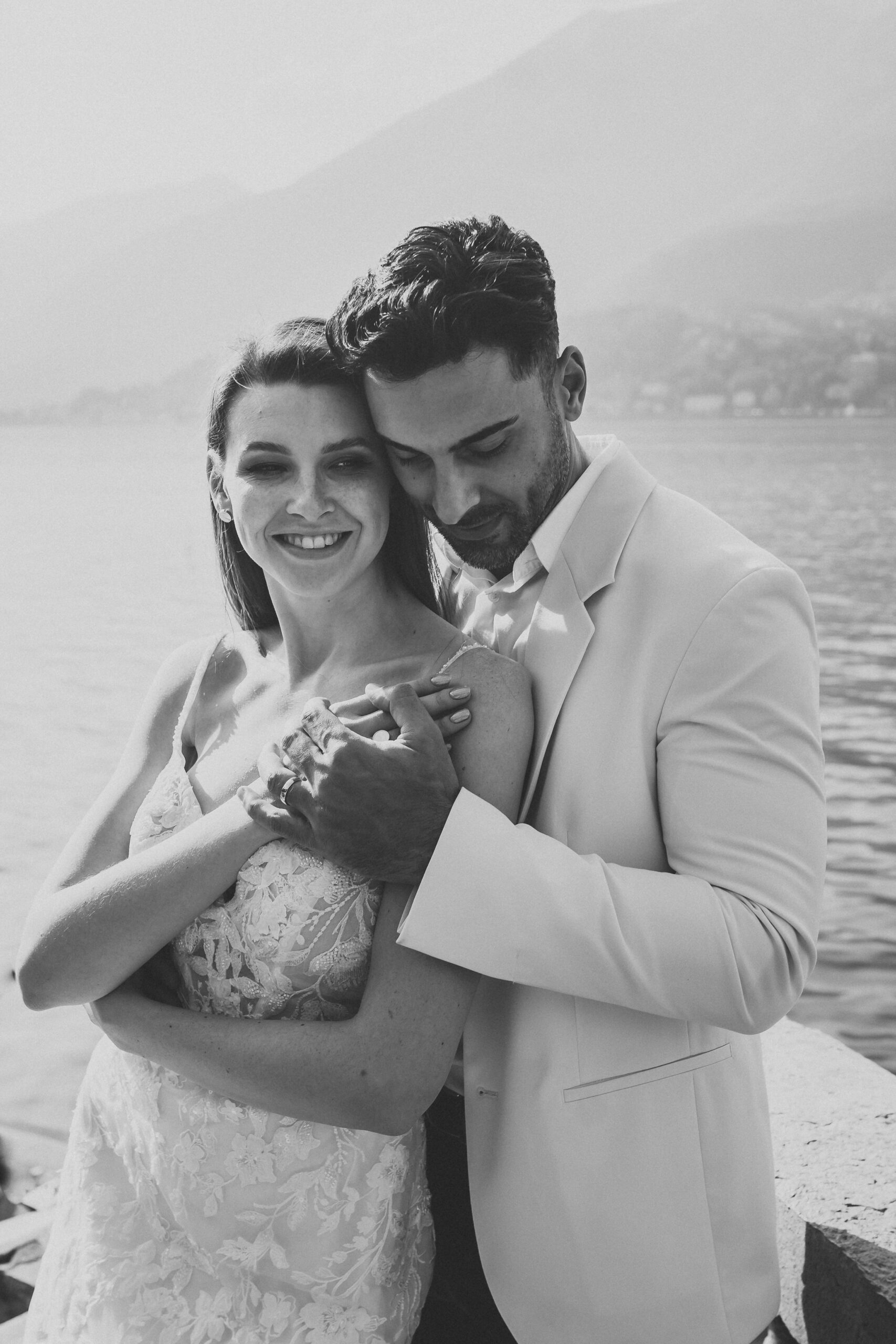 a groom cuddling on to his wife after their lake como wedding 