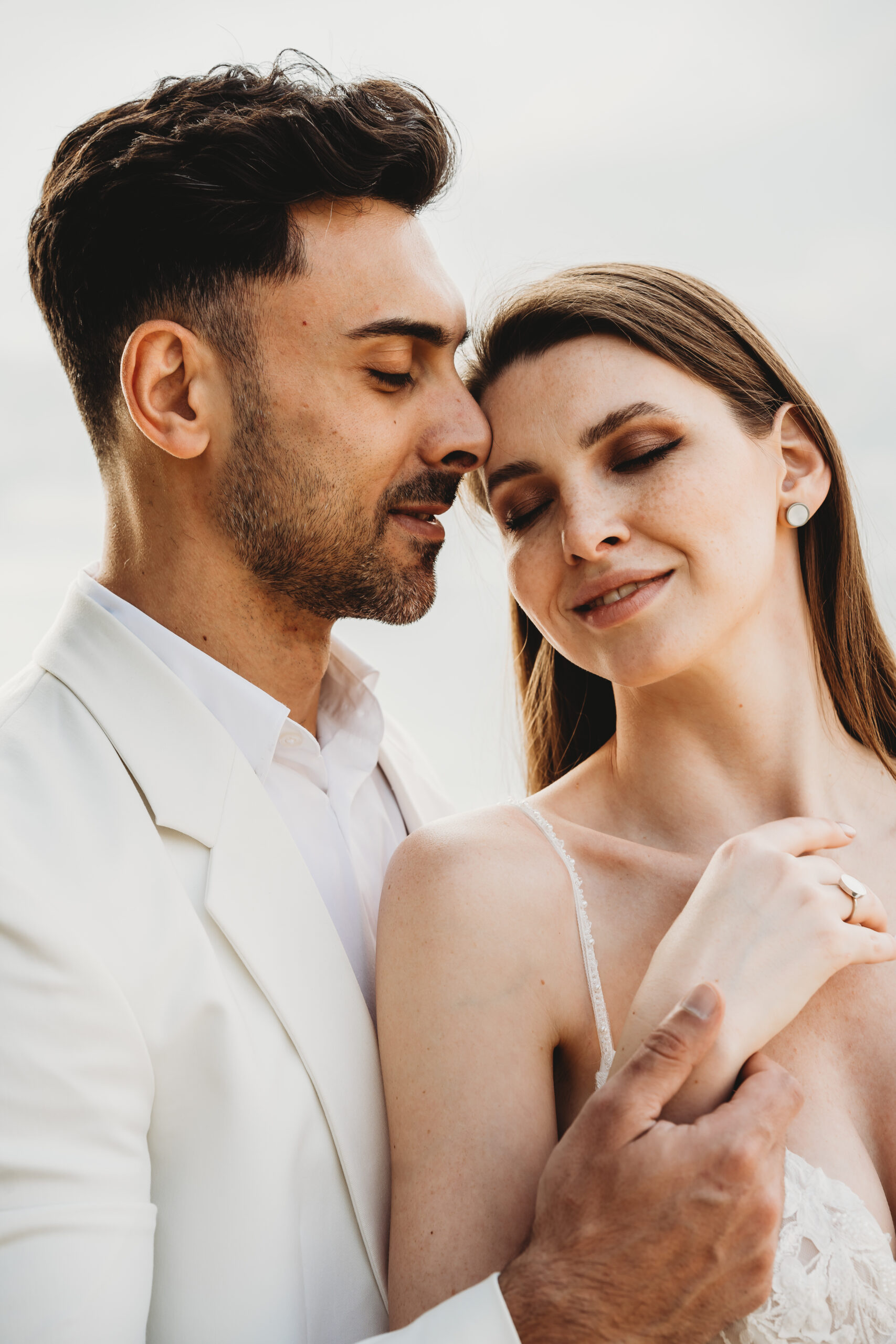 a bride and groom snuggling in together for their italian wedding photographer