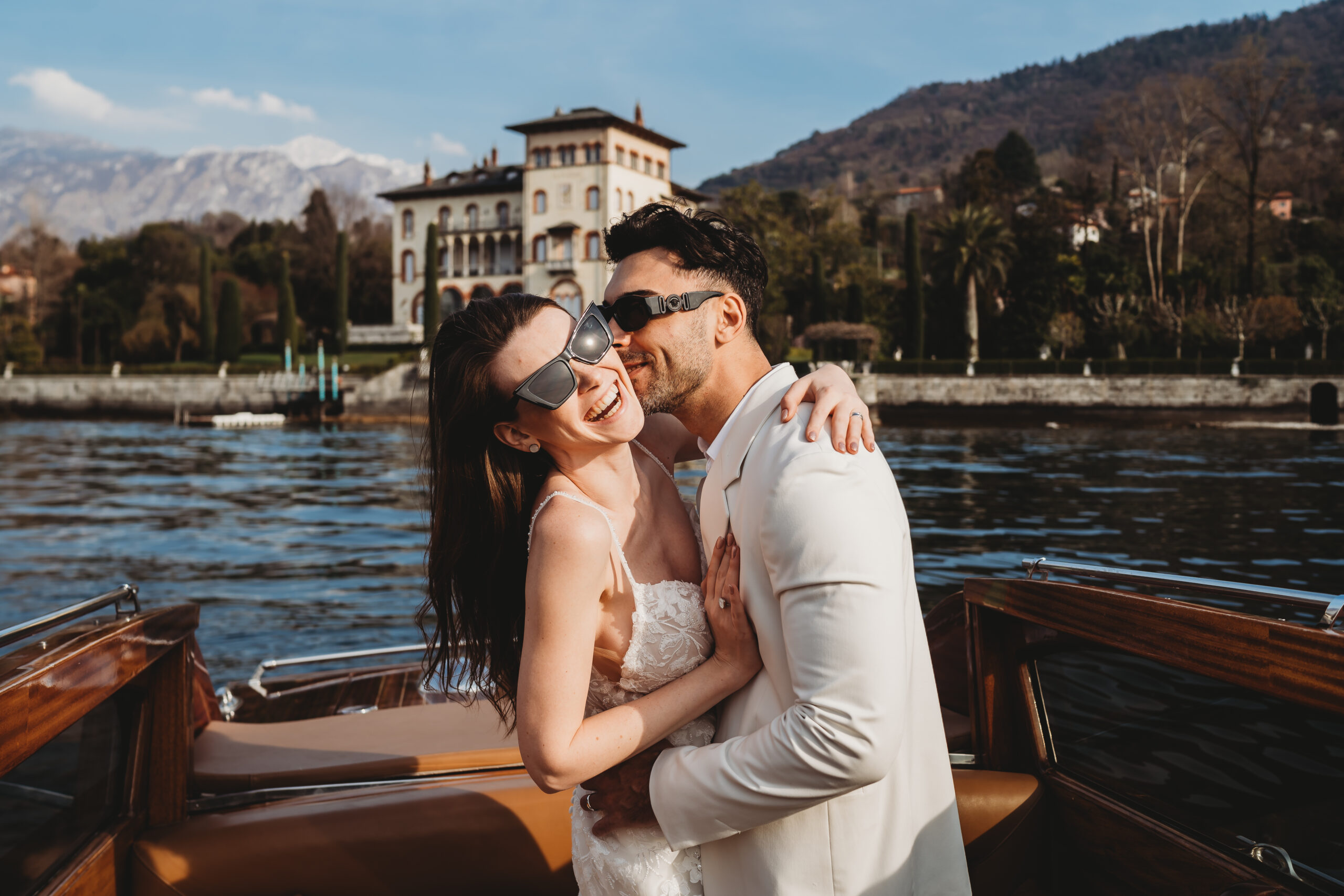 a couple laughing a hugging on a beautiful italian boat