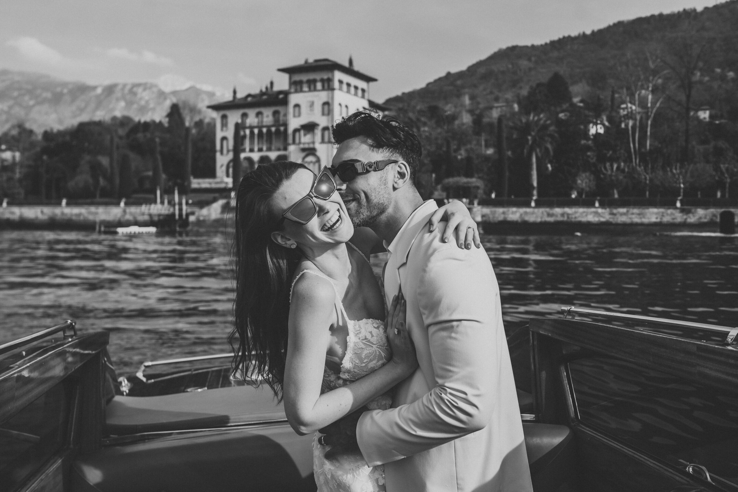 a newly wed couple laughing and cuddling taken by a lake como photographer