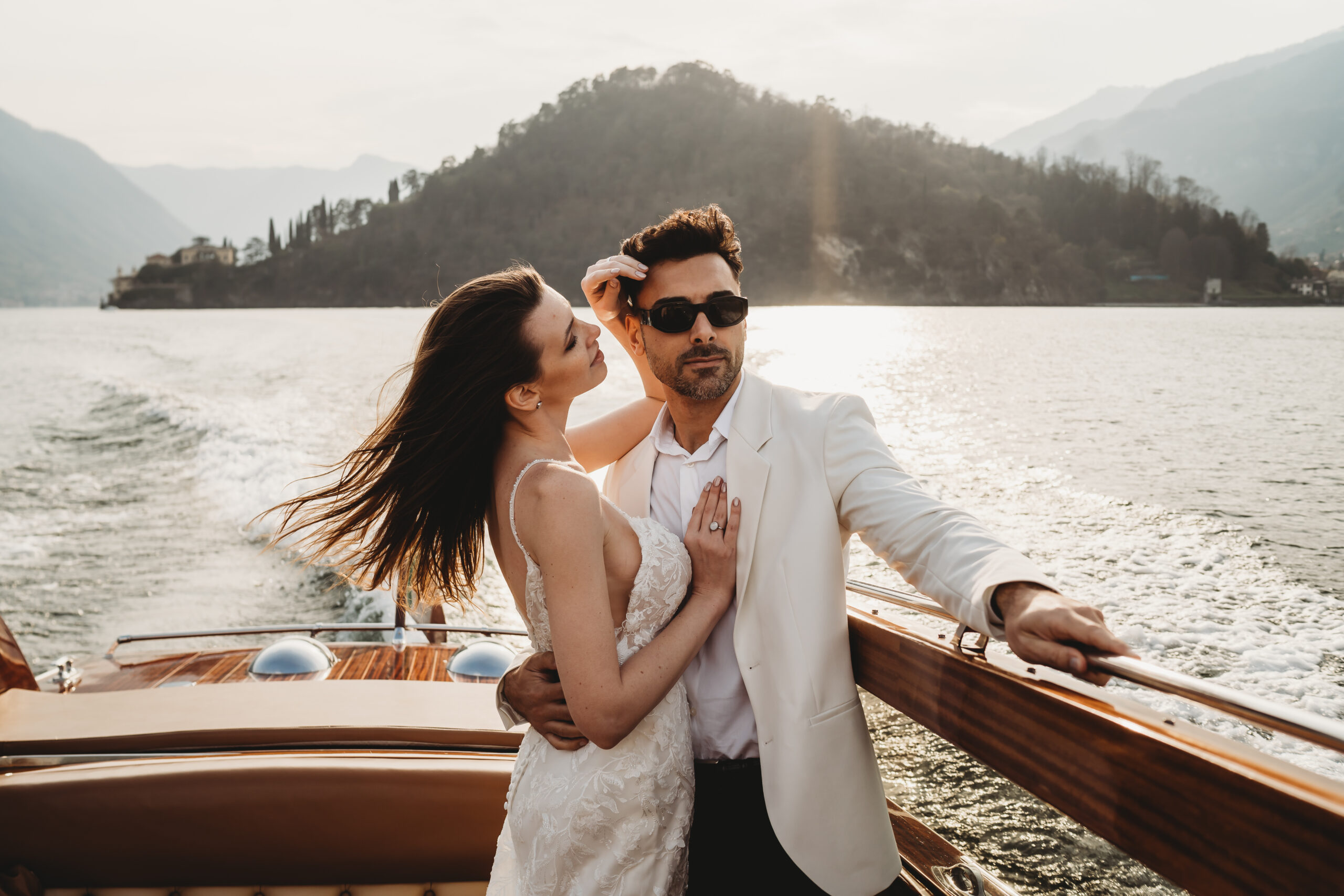 a groom pulling his wife in for a cuddle taken by a lake como photographer