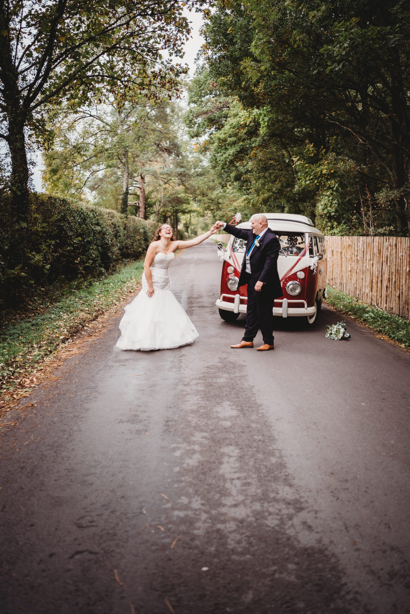 a bride and groom dancing in front of their wedding vw van following their wedding