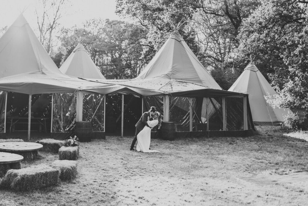 a bride and groom doing a drop kiss at Woolley Park Estate