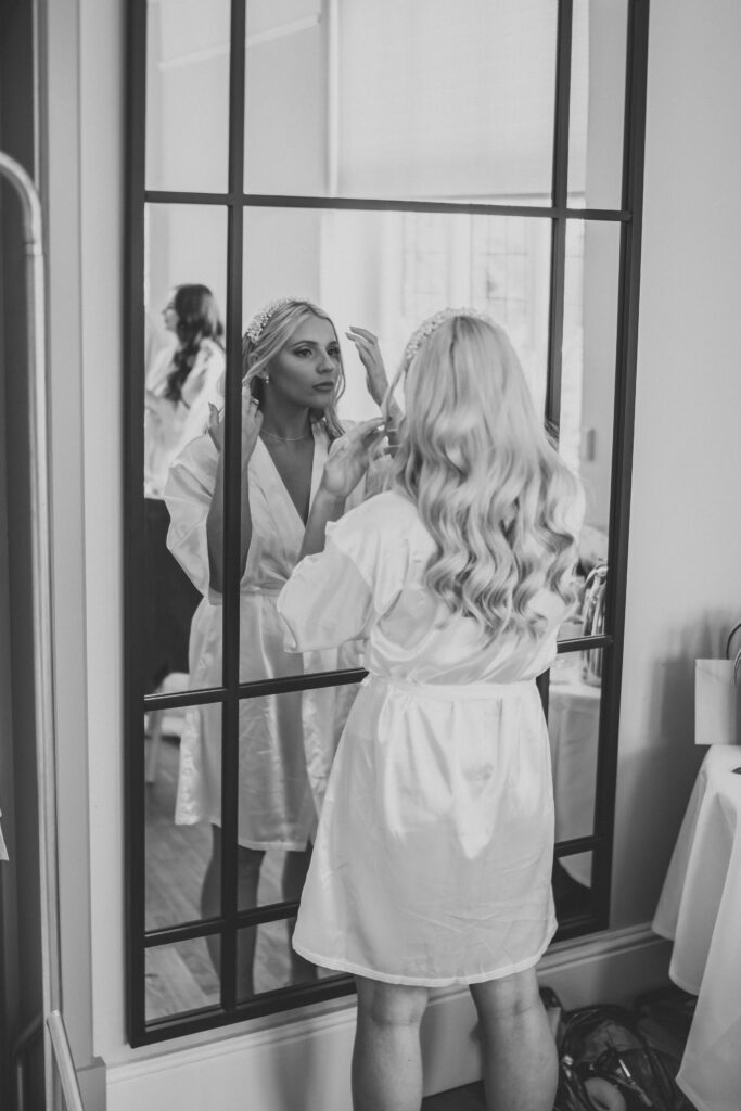 newbury wedding photography of a bride checking her make up in the mirror 