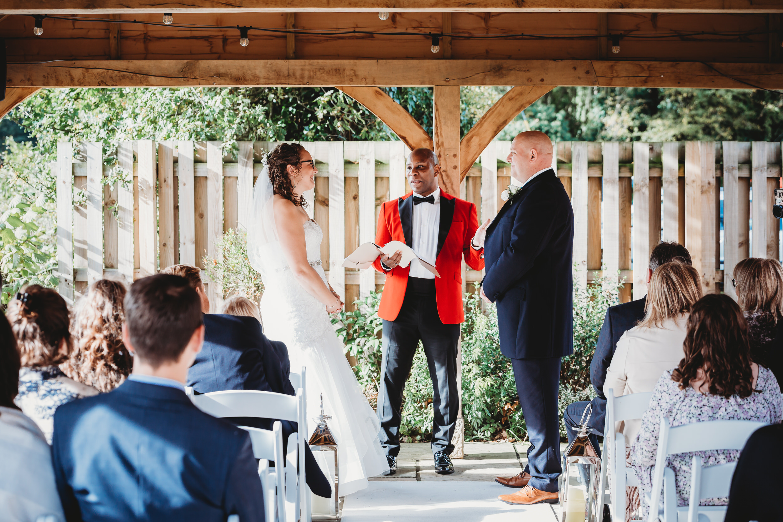 a bride and groom being married by a celebrant during an outdoor ceremony taken by a hampshire wedding photographer