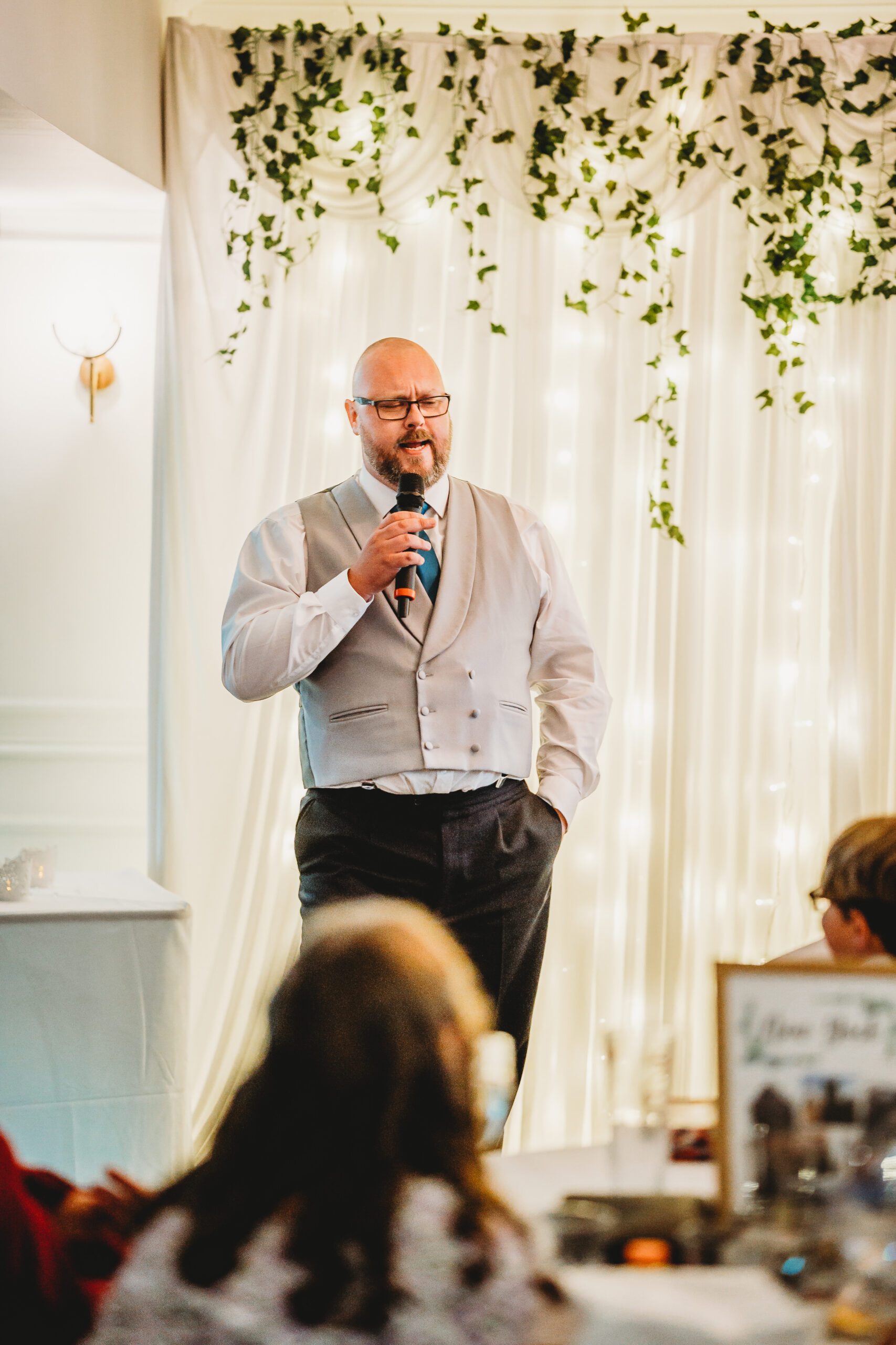a best man stood giving a speech to a groom during a hampshire wedding