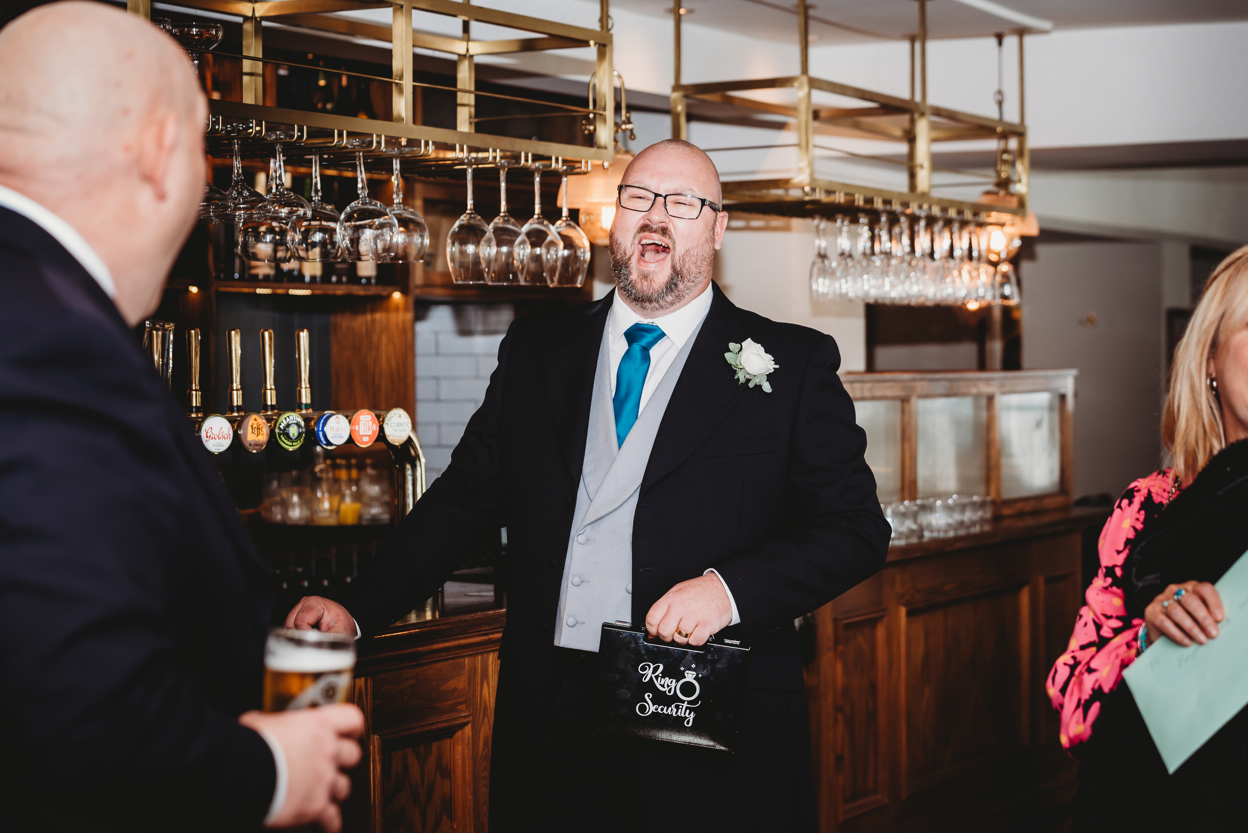 a best man propping himself up at a bar before the wedding 